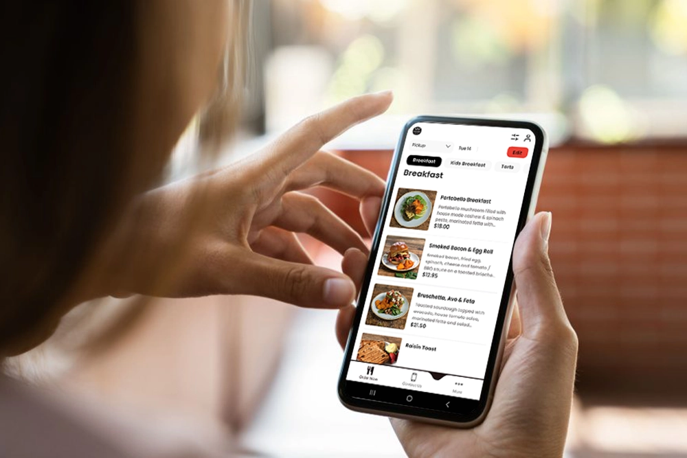woman ordering breakfast on Village Bakehouse app